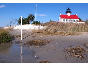 This Nov. 10, 2018, photo shows the Delaware Bay approaching the East Point Lighthouse in Maurice River Township, N.J. Rising seas and erosion are threatening lighthouses around the U.S. and the world, including the East Point Lighthouse. With even a moderate-term fix likely to cost $3 million or more, New Jersey officials are considering what to do to save the lighthouse.