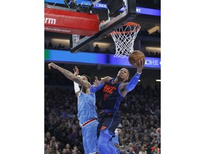 Oklahoma City Thunder guard Russell Westbrook (0) drives to the basket past Sacramento Kings center Willie Cauley-Stein, left, during the first half of an NBA basketball game in Sacramento, Calif., Monday, Nov. 19, 2018.