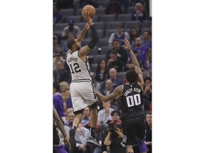 San Antonio Spurs forward LaMarcus Aldridge, left, shoots over Sacramento Kings center Willie Cauley-Stein during the first quarter of an NBA basketball game Monday, Nov. 12, 2018, in Sacramento, Calif.