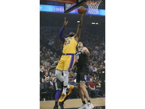 Los Angeles Lakers forward LeBron James, left, goes to the basket against Sacramento Kings forward Nemanja Bjelica during the first quarter of an NBA basketball game Saturday, Nov. 10, 2018, in Sacramento, Calif.