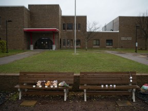 Teddy bears, flowers, and candles were placed on benches outside Halmstad Elementary School in Chippewa Falls, Wis. as a memorial to the three Girl Scouts who were struck and killed by a driver who fled the scene, Sunday, Nov. 4, 2018. The western Wisconsin community is grieving the deaths of three girls and an adult who were collecting trash along a rural highway when police say a pickup truck veered off the road and hit them before speeding away.