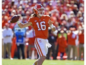 Clemson's Trevor Lawrence drops back to pass during the first half of an NCAA college football game against Louisville, Saturday, Nov. 3, 2018, in Clemson, S.C.