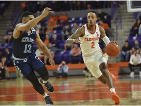 Clemson's Marcquise Reed dribbles to the basket while defended by The Citadel's Lew Stallworth during the first half of an NCAA college basketball game Tuesday, Nov. 6, 2018, in Clemson, S.C.