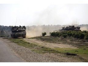 Israeli tanks move near the Israel Gaza border, Tuesday, Nov. 13, 2018.