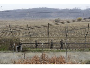 South Korean army soldiers patrol along the barbed-wire fence in Paju, South Korea, near the border with North Korea, Friday, Nov. 16, 2018. North Korean leader Kim Jong Un observed the successful test of "a newly developed ultramodern tactical weapon," the nation's state media reported Friday, though it didn't describe what sort of weapon it was.