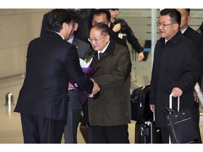 North Korean vice chairman of the Korea Asia-Pacific Peace Committee Ri Jong Hyok, second from left, is greeted by an unidentified South Korean officer upon his arrival at the Incheon International Airport in Incheon, South Korea, Wednesday, Nov. 14, 2018. A five-member North Korean delegation is visiting South Korea to attend an academic forum on Japan's wartime actions.