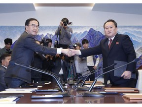 FILE - In this Oct. 15, 2018, file photo, South Korean Unification Minister Cho Myoung-gyon, left, shakes hands with his North Korean counterpart Ri Son Gwon after exchanging the joint statement during their meeting at the southern side of Panmunjom in the Demilitarized Zone, South Korea. South Korea says the United Nations Security Council has granted sanctions exemption for surveys on North Korean railroad sections the Koreas want to connect with the South. (Korea Pool/Yonhap via AP, File)