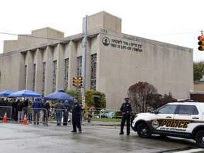 Police direct traffic at the Tree of Life Synagogue on Saturday, Nov. 3, 2018, as a curbside Shabbat morning service is held following the massacre of 11 worshippers.