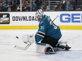 San Jose Sharks goaltender Martin Jones (31) makes a save against the Calgary Flames in the first period of an NHL hockey game in San Jose, Calif., Sunday, Nov. 11, 2018.
