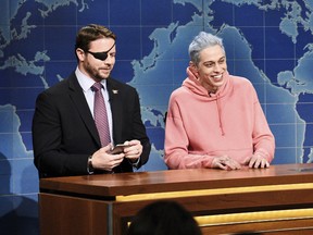 From left, Lt. Com. Dan Crenshaw, a congressman-elect from Texas, and Pete Davidson, during SNL's Weekend Update in New York.