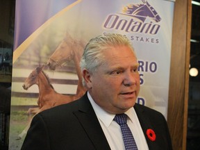 Premier Doug Ford speaks with reporters Friday following a tour of the Hiawatha Horse Park in Sarnia.