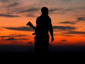 An Israeli soldier is silhouetted against the sky in the southern Israeli town of Sderot on Nov. 13, 2018.