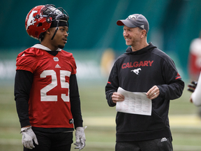 Calgary Stampeders Don Jackson and head coach Dave Dickenson chat during practice in preparation for the Grey Cup in Edmonton, Nov. 21, 2018.