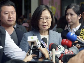 Taiwanese President Tsai Ing-wen, center, speaks after a local election vote in New Taipei City, Taiwan.
