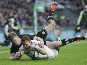 England's Chris Ashton scores a try during the rugby union international match between England and New Zealand at Twickenham stadium in London, Saturday, Nov. 10, 2018.