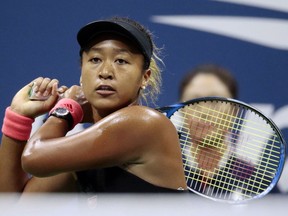 FILE - In this Sept. 8, 2018, file photo, Naomi Osaka, of Japan, returns a shot to Serena Williams fo the U.S. during the women's final of the U.S. Open tennis tournament, in New York. Osaka is headed for big money with both Japanese and global appeal. Among companies vying to cash in on her stardom is Tokyo-based Citizen Watch Co. Its 80,000 yen ($700) Naomi Osaka watch is selling out after it got a lot of exposure on her wrist at the U.S. Open, where she beat Williams.