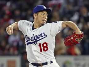 MLB All-Star starter Kenta Maeda of the Los Angeles Dodgers pitches against All Japan in the first inning of Game 4 of their All-Stars Series baseball at Mazda Zoom-Zoom Stadium in Hiroshima, western Japan, Tuesday, Nov. 13, 2018. (Kyodo News via AP)