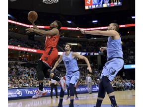 Toronto Raptors guard Kyle Lowry (7) shoots against Memphis Grizzlies forward Omri Casspi (18) and center Marc Gasol in the first half of an NBA basketball game, Tuesday, Nov. 27, 2018, in Memphis, Tenn.