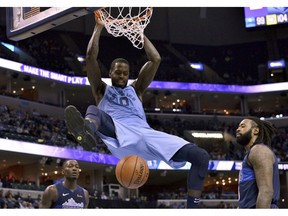 Memphis Grizzlies forward JaMychal Green (0) dunks the ball between Dallas Mavericks forward Dorian Finney-Smith, left, and center DeAndre Jordan in the second half of an NBA basketball game Monday, Nov. 19, 2018, in Memphis, Tenn.