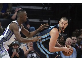 Memphis Grizzlies' Marc Gasol (33) looks to pass while guarded by Sacramento Kings' Harry Giles lll during the first half of an NBA basketball game Friday, Nov. 16, 2018, in Memphis, Tenn.