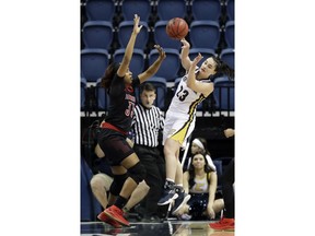 Chattanooga guard Brooke Burns (23) passes past Louisville forward Bionca Dunham (33) in the first half of an NCAA college basketball game Friday, Nov. 9, 2018, in Chattanooga, Tenn.