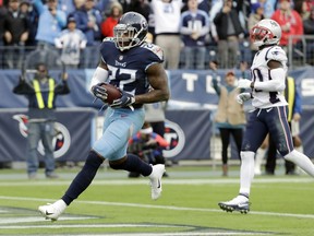Tennessee Titans running back Derrick Henry (22) scores a touchdown on a 10-yard run ahead of New England Patriots cornerback Jason McCourty, right, in the second half of an NFL football game Sunday, Nov. 11, 2018, in Nashville, Tenn.