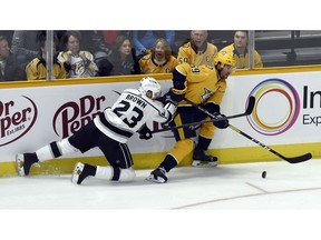 Nashville Predators defenseman Roman Josi (59), of Switzerland, maneuvers the puck past Los Angeles Kings right wing Dustin Brown (23) during the first period of an NHL hockey game Saturday, Nov. 17, 2018, in Nashville, Tenn.