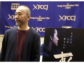 In this Nov. 7, 2018, photo, Japanese director Shinya Tsukamoto speaks to reporters about his latest film "Killing" during a press conference in Tokyo. He said he turned to the Japanese masters for inspiration but also emulated the way Martin Scorsese gave free rein to his actors, a technique he learned when he was cast in "Silence," to play a Christian martyr. "Killing," a poetic but brutal story about the horrors of violence, premiered at the Venice Film Festival earlier this year and opens in Japan on Nov. 24.