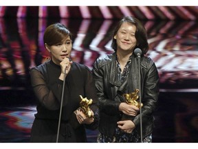 Taiwanese director Fu Yue, left, delivers a speech next to producer Hong Ting Yi after she won Best Documentary at the 55th Golden Horse Awards in Taipei, Taiwan, Saturday, Nov. 17, 2018. Her film "Our Youth in Taiwan" won best documentary at the awards. Taiwan's president expressed her support for the prestigious Golden Horse film awards after a pro-Taiwan independence director's speech ignited controversy in mainland China. Fu said during her acceptance speech Saturday that her biggest hope was for "our country" to be regarded as an "independent entity." (Taipei Golden Horse Film Festival Executive Committee via AP)