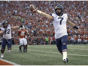 FILE - In this Nov. 3, 2018, file photo, West Virginia quarterback Will Grier (7) scores the game-winning two-point conversion during an NCAA college football game against Texas, in Austin, Texas.  Grier, a senior, will play in his final home game Friday night, Nov. 23, when No. 12 West Virginia hosts No. 6 Oklahoma.