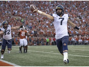 FILE - In this Saturday, Nov. 3, 2018, file photo, West Virginia quarterback Will Grier (7) scores the game-winning, two-point conversion during an NCAA college football game against Texas in Austin, Texas. Grier has thrown for 699 yards and six touchdowns without an interception in his last two games.