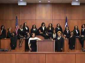 This photo provided by the Harris County Democratic Party shows a group of 17 African-American women whom are part of an effort dubbed the "Black Girl Magic" campaign. It is the largest number of African-American women on any ballot in the history of Harris County, where Houston is located. In the photo are the 17 women who won election and two others who are currently judges in Harris County but lost bids on Tuesday to win seats on the Texas Court of Criminal Appeals. Tuesday's election brings to 19 the number of African-American women who will be judges in Harris County. Front row, leaning against the podium from left, are Maria Jackson and Ramona Franklin. Back row, from left, are Lucia Bates, Erica Hughes, Sandra Peake, Cassandra Holleman, Germaine Tanner, Ronnisha Bowman, Linda Marie Dunson, Angela Graves-Harrington, Dedra Davis, Shannon Baldwin, Latosha Lewis Payne, Tonya Jones, Sharon Burney, Michelle Moore, Lori Chambers Gray, Toria Finch and LaShawn Williams. Maria Jackson and Ramona Franklin in front row are the two women who are currently judges but lost bids to win seats on the Texas Court of Criminal Appeals.