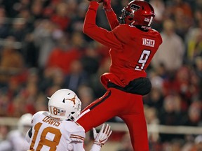 Texas Tech's T.J. Vasher (9) catches a touchdown pass over Texas Davante Davis during the first half of an NCAA college football game Saturday, Nov. 10, 2018, in Lubbock, Texas.