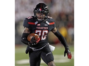 Texas Tech's Ta'Zhawn Henry (26) runs the ball to score a touchdown during the first half of an NCAA college football game against Oklahoma, Saturday, Nov. 3, 2018, in Lubbock, Texas.