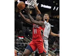New Orleans Pelicans' Jrue Holiday (11) shoots against San Antonio Spurs' Rudy Gay during the first half of an NBA basketball game, Saturday, Nov. 3, 2018, in San Antonio.