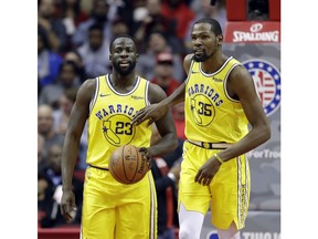 Golden State Warriors' Kevin Durant (35) pats Draymond Green (23) on the chest after a turnover during the second half of an NBA basketball game against the Houston Rockets Thursday, Nov. 15, 2018, in Houston.