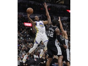 Golden State Warriors guard Andre Iguodala (9) looks to pass the ball as San Antonio Spurs forward LaMarcus Aldridge (12) defends during the first half of an NBA basketball game Sunday, Nov. 18, 2018, in San Antonio.
