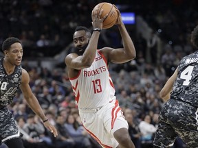 Houston Rockets guard James Harden (13) drives around San Antonio Spurs guard DeMar DeRozan (10) during the first half of an NBA basketball game, Saturday, Nov. 10, 2018, in San Antonio.