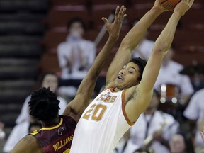 Texas forward Jericho Sims (20) pulls down a rebound over Louisiana Monroe guard JD Williams (3) during the first half of an NCAA college basketball game, Monday, Nov. 12, 2018, in Austin, Texas.