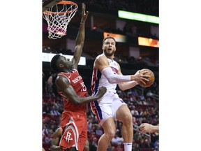 Detroit Pistons forward Blake Griffin, right, drives to the basket as Houston Rockets center Clint Capela defends during the first half of an NBA basketball game Wednesday, Nov. 21, 2018, in Houston.