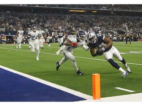 Dallas Cowboys wide receiver Amari Cooper (19) runs into the end zone as Tennessee Titans cornerback Malcolm Butler (21) defends during the first half of an NFL football game, Monday, Nov. 5, 2018, in Arlington, Texas.