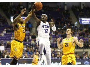 TCU forward Kouat Noi (12) drives past Lipscomb defenders Kenny Cooper (21) and Garrison Mathews (24) during the first half of an NCAA college basketball game, Tuesday, Nov. 20, 2018, in Fort Worth, Texas.