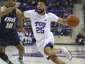 Oral Roberts guard Sam Kearns (10) tries to defend against the drive by TCU guard Alex Robinson (25) in the first half an NCAA college basketball game Sunday, Nov. 11, 2018, in Dallas.