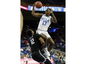 UCLA guard Kris Wilkes, top, goes to the basket while Long Beach State forward Breyon Jackson defends during the first half of an NCAA college basketball game Friday, Nov. 9, 2018, in Los Angeles.