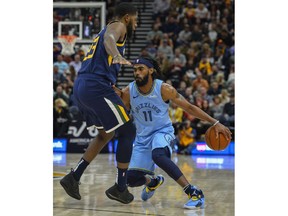 Memphis Grizzlies guard Mike Conley (11) attempts to drive around Utah Jazz forward Royce O'Neale (23) during the first half of an NBA basketball game Friday, Nov. 2, 2018, in Salt Lake City.