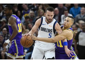 Utah Jazz guard Dante Exum (11) guards Dallas Mavericks guard J.J. Barea (5) during the first half of an NBA basketball game Wednesday, Nov. 7, 2018, in Salt Lake City.