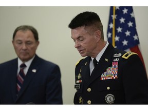 Gov. Gary Herbert, left, and Maj. Gen. Jefferson S. Burton address the media on Sunday, Nov. 4, 2018, in Draper, Utah. Military officials say a major in Utah's Army National Guard who was also the mayor of a city north of Salt Lake City was killed in Afghanistan after being shot by a member of the Afghan security forces. They say Brent Taylor was in the country to train Afghan commandos and was shot Saturday, Nov. 3, 2018, by one of the trainees at the Kabul military training center. The attacker was then killed by Afghan forces.