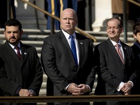Acting United States Attorney General Matt Whitaker, center, and Labor Secretary Alex Acosta, second from right, attend a wreath laying ceremony at the Tomb of the Unknown Soldier during a ceremony at Arlington National Cemetery on Veterans Day, Sunday, Nov. 11, 2018, in Arlington, Va.
