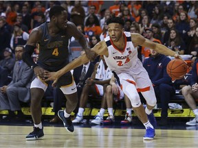 Virginia guard Marco Anthony (24) drives past Coppin State guard Tre' Thomas (4) during the second half of an NCAA college basketball game Friday, Nov. 16, 2018, in Charlottesville, Va.