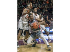 Virginia Tech forward P.J. Horne (14) and guard Wabissa Bede, right, defend against Gardner-Webb forward Eric Jamison Jr. during the first half of an NCAA college basketball game Friday, Nov. 9, 2018, in Blacksburg, Va.